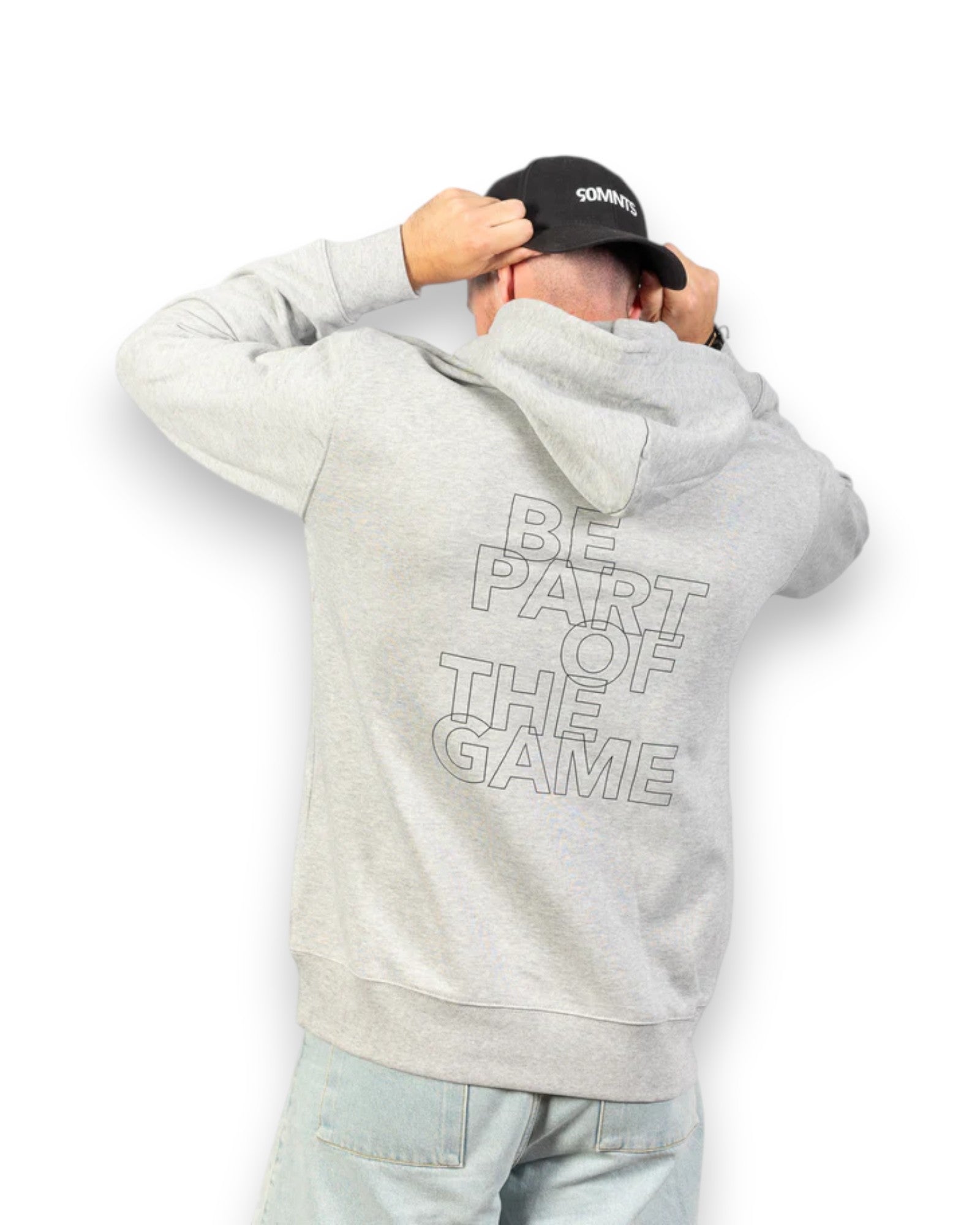 Model trägt BE PART OF THE GAME Hoodie in Grau mit Print in Schwarz